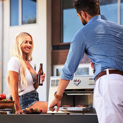 Man and Woman Grilling Steak in the Backyard