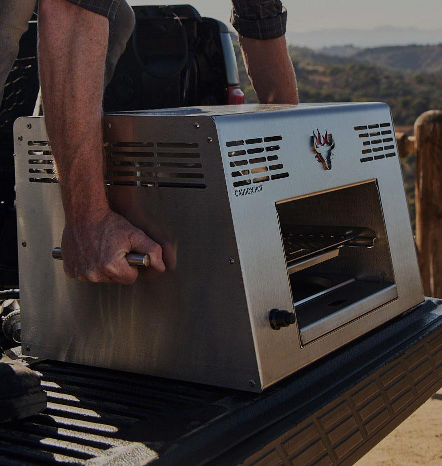 Man carrying Schwank Grill by side handles