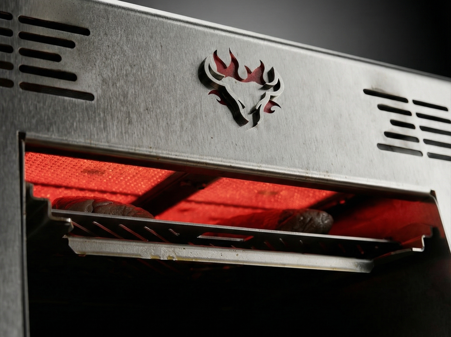 Close-up of a grill with a logo on the lid